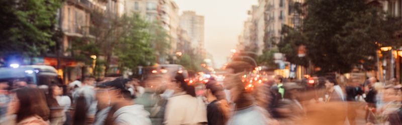 crowd of people walking across a busy road