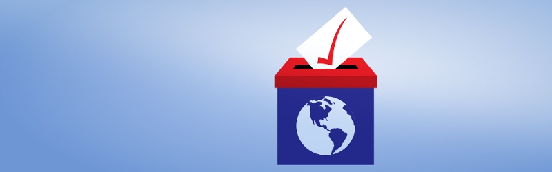Image of a vote being cast into a ballot box.