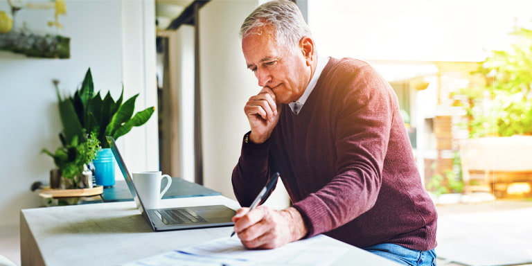 Investment account image of someone investing on their laptop