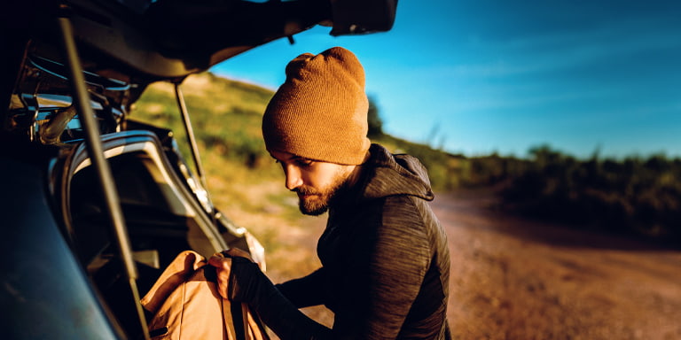 Sustainable investing image of someone placing a bag in the boot of their car